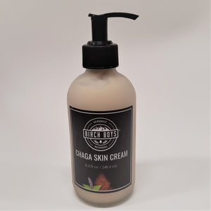 Clear bottle with black spout top and black label centered on bottle. The label has white type CHAGA SKIN CREAM and the Birch Boys logo centered on top