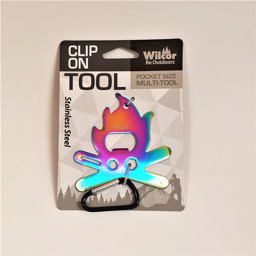 Clip-on Camper Fire Tool in packaging. Stainless steel campfire appears with a purply pink center and blueish bottom above the black and silver carabiner clip.