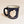 A single dark blue-with-white speckled camp mug with the words SARANAC LAKE, NY on the bottom and a white-filled outline of the Adirondack Park in the center. There is a small dark blue heart in the white outline located where Saranac Lake sits. The mug has a black rim and white interior.
