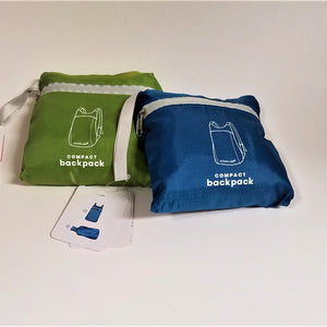 Green and blue zipped nylon packages containing the folded up compact backpack.