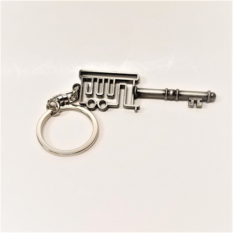 Key ring on white background. Ring for keys to the left of the skeleton like cure porch with a skeleton-like key coming our of the porch on the right