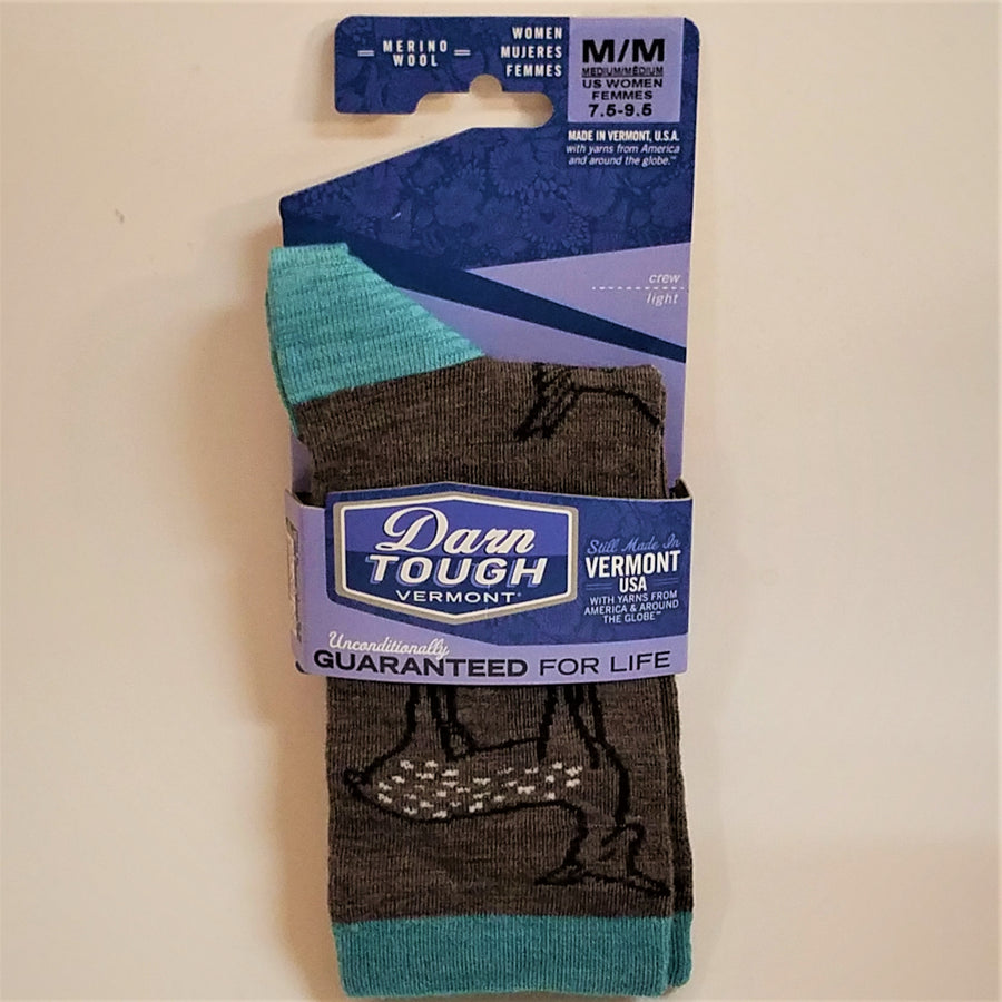 Full view of Women's Darn Tough socks in blue labeled packaging. Solid charcoal with fawn oulined in navy with white dots on the body; aqua heel and cuff