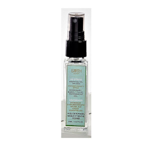Single glass bottle of Earth Luxe De-Stress Aromatherapy spray standing upright. The top has a black spray dispenser seen through its plastic cover. A pale teal-colored vertical product label fills the front side of the bottle.