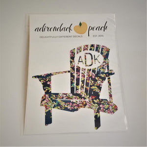 Decal of Adirondack chair in floral pattern with white oval and matching flora lettering ADK on chair back.