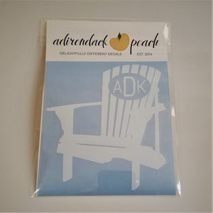 Decal of Adirondack chair in white with an oval and white lettering ADK on chair back.