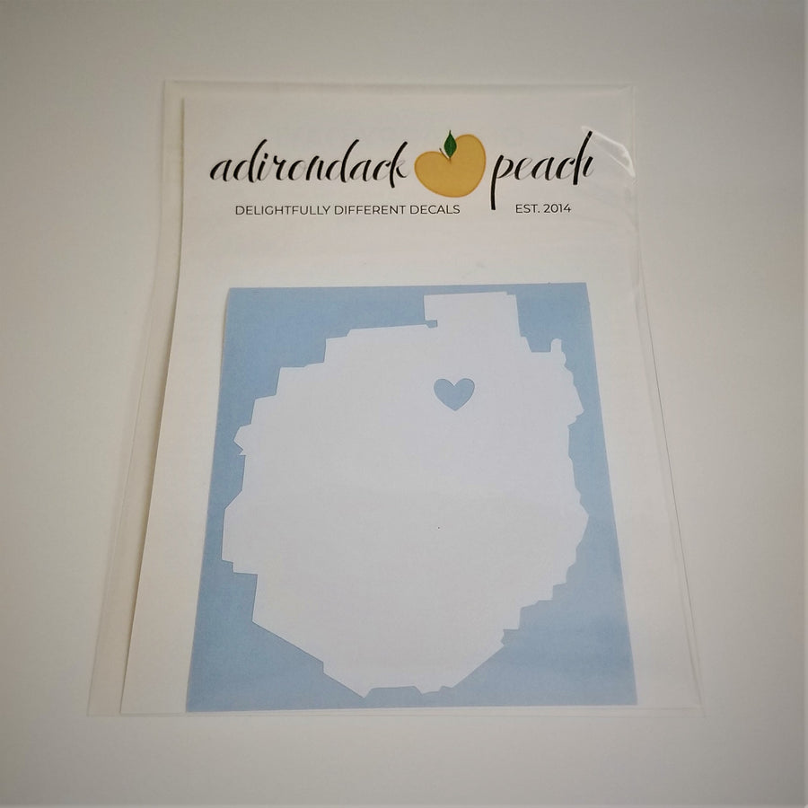 Single white decal in shape of Adirondack Park with blue heart in top third slightly off center, on a blue background.