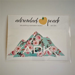 Adirondack mountain decal in aqua floral pattern with white ADK lettering printed at the base of the mountain