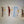 Fanned out display of Adirondack Peach half pine tree decals. Four packets display the pink aztec, buffalo plaid, white and navy floral patterns.