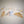Fanned out display of Adirondack mountains decals in wood grain pattern, aqua floral, white, and yellow floral with white ADK lettering printed at the base of the mountain range seen on some and peaking through.
