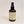 Standing brown bottle of Eucalyptus therapeutic spray  with pale yellow label facing forward.