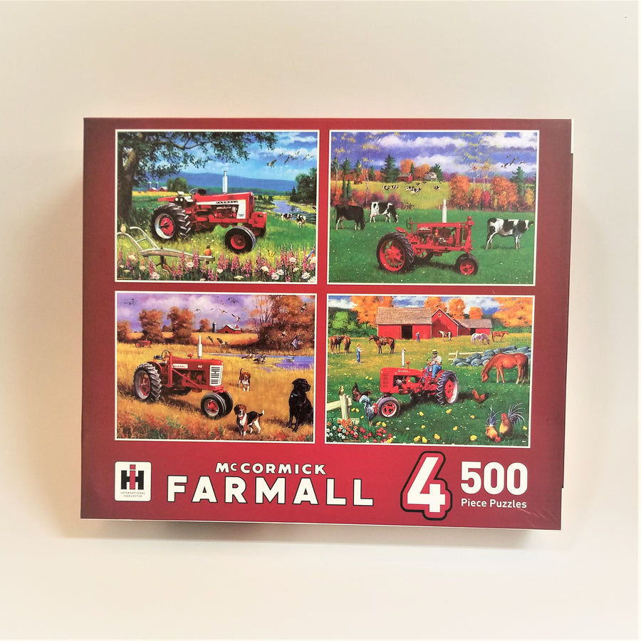 Box cover of McCormick Farmall 500 piece puzzles. Four separate farm-scene illustrations, all featuring a tractor and animals on the farm.