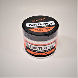 A white container with a black twist lid and orange and black label. A gray footprint appears to the left of the words Foot Therapy.