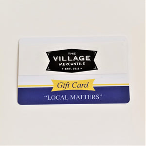 Village Mercantile Gift Card photographed flat. Blue border on bottom with words: "LOCAL MATTERS"