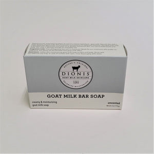 Dionis Goat Milk Bar Soap in its boxed package. Gray top with Dionis circle logo in center above white strip with black type. 