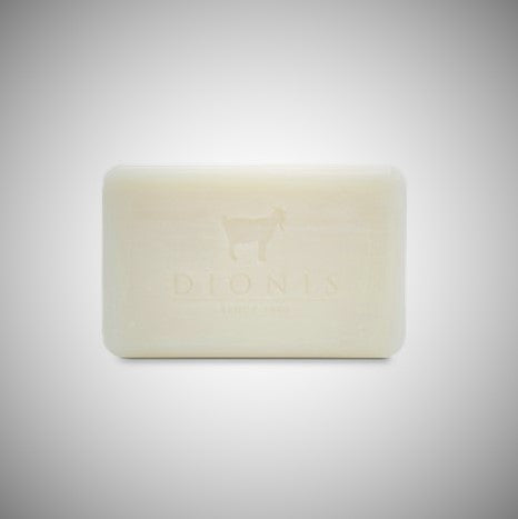 Unscented DIonis Goat Milk Soap out of box standing flat. Image of a goat and DIONIS type can be scene faintly etched into the soap.