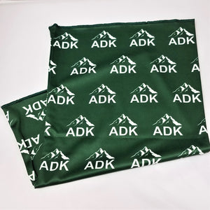 Green neck gaiter and mask folded up with white ADK lettering and mountains on the green background.