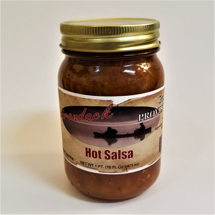 Glass jar of Hot Salsa.  Red sauce with glimpses of seeds and pepper can be seen through the glass under the gold screw top.