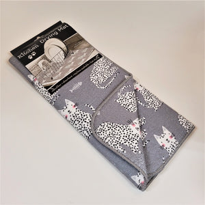 Cat Countertop mat in packaging the pattern showing is  a white cat with black polka dots and a small boned fish on a gray background.
