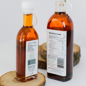The back of two Maple Vinaigrette bottles with labels showing Nutrition Facts and Ingredients.