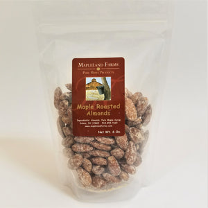 Standing bag of Mapleland Farms Maple Roasted Almonds with label top-centered and almonds showing through the clear plastic bag.
