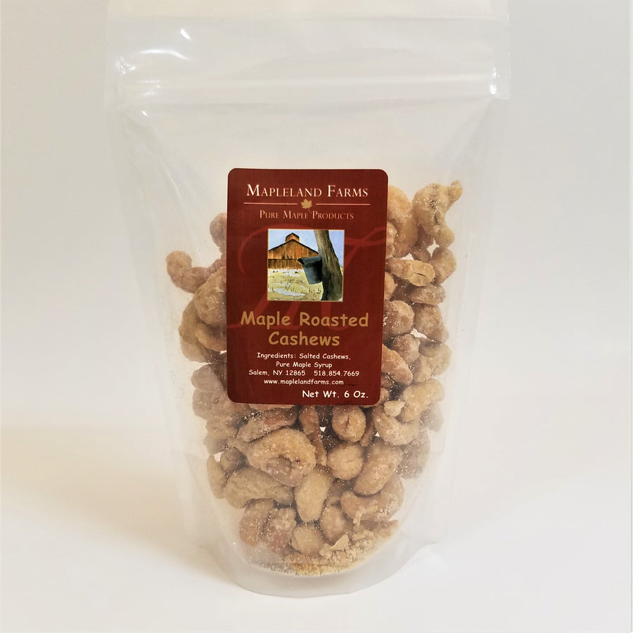 Standing bag of Mapleland Farms Maple Roasted Cashews with label top-centered and cashews showing through the clear plastic bag.