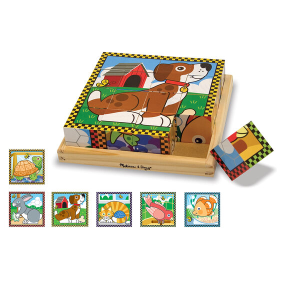 Cube dog puzzle featured in center with one cube coming out of the wooden frame. Images of all 6 puzzle subjects: turtle, rabbit, dog, cat, bird and fish border the bottom and left side.