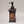 The front of the moose soap dispenser. A dark rectangular standing dispenser with a vertical, rectangular picture of a moose in amber shades under the metallic push spout.