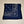Workman's navy blue bandana folded square with paisley white print around corner edge