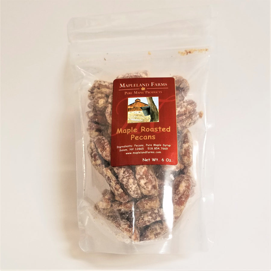 Standing bag of Mapleland Farms Maple Roasted Pecans with label top-centered and pecans showing through the clear plastic bag.