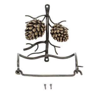 Metal toilet paper holder with two pine cones in vertical position.