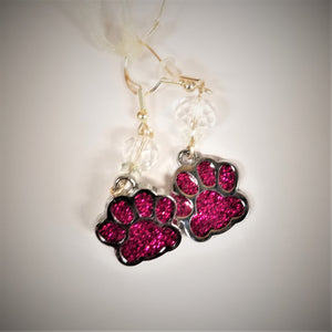 Red glass in silver framed paw earrings with a clear glass bead above and under the metal hooks.