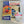 Boxed Fruit & Seed Bird Feeder set. Through the clear plastic panel can be seen part of the wooden frame, paint brushes and blue and yellow paint. The box features an image of what the completed project could look like along with specs on what is included.
