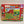Puzzle cover of 101 things to spot on the farm with red border and a red barn surrounded by  colorful fields and farm animals.