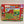 Puzzle cover of 101 things to spot on the farm with red border and a red barn surrounded by colorful fields and farm animals.