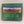 Cover of Adirondack Panoramic Jigsaw Puzzle Box features a green border surrounding an autumn-colored mountain and valley scene. Below the photo is a reference chart of the mountains depicted.