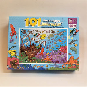 Puzzle box cover for 101 things to spot underwater. Blue border with various sea images.  A thin white border surrounds a brown shipwreck and lots of colorful underwater life, treasure and more.