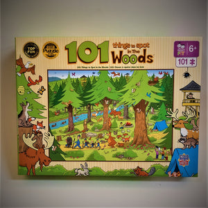 Puzzle box cover for 101 things to spot in the woods. Pale yellow border with animals, ranger and tent on the sides. The picture in the middle is of thick brown trees with ever-green tops, a blue river with mallard ducks, greenery with yellow paths with boy scouts hiking followed by bears.