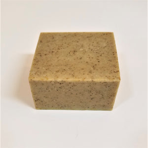 Square bar of No Bite Me Soap. Beige bar with brown specs on the top and front side.