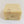 Off-white soap bar with gray specks on front side and gray and pale yellow specks on top.
