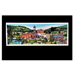 Panoramic print in full color of downtown Saranac Lake including Harrietstown  Town Hall, the Hotel Saranac  and more in the background set  within a white border and a black frame.