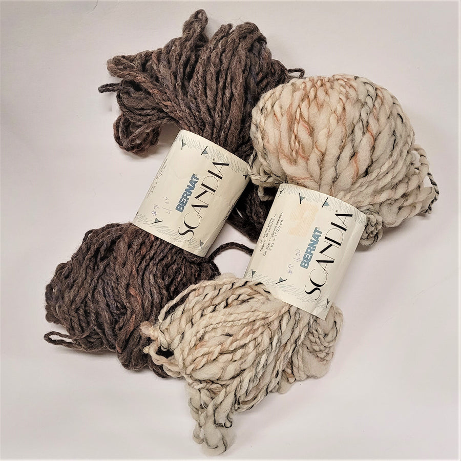 Two skeins of yarn--left, various shades of deep brown, right cream-colored mesh with black, brown and gray strands both have the Bernat Scandia label in the center.