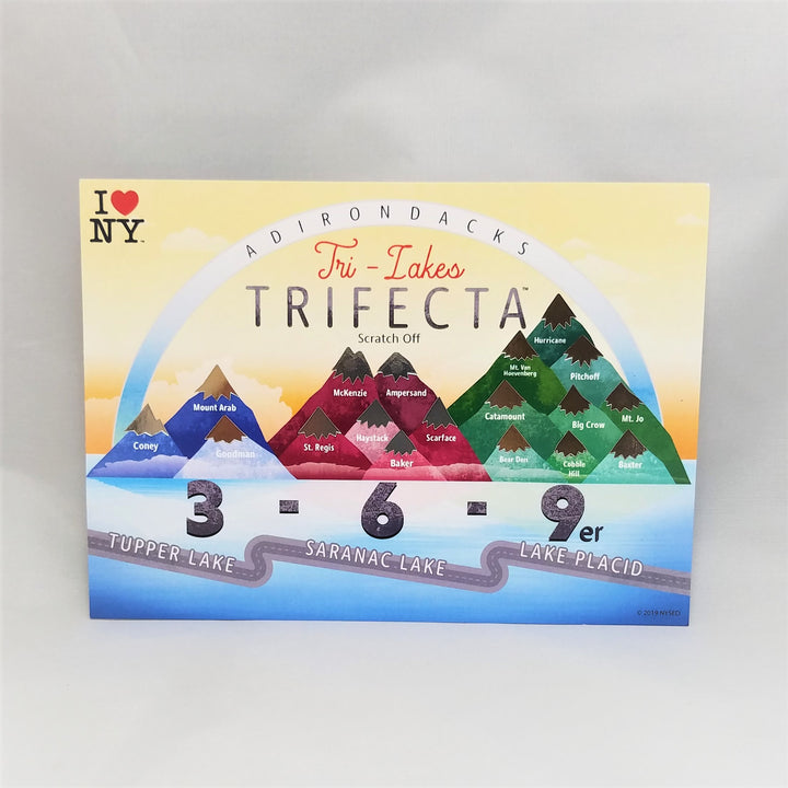 Full horizontal view of scratch-off card with blue pyramid mountains, growing to red pyramid mountains, to green pyramid mountains set over the numbers 3 - 6- 9 with a riverscape underneath