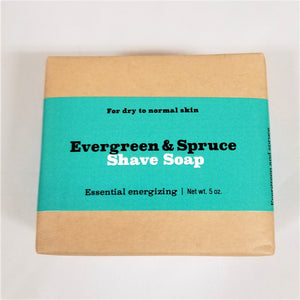 Evergreen and spruce shave soap flat in its natural wrapping with turquoise-colored label in center.