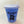 Baby blue sippy cup standing upright with clear top attached