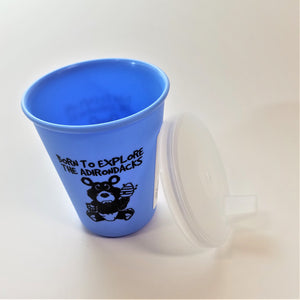 Baby blue sippy cup standing upright with clear spouted top leaning alongside