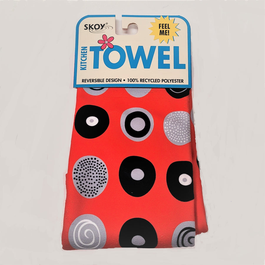 Red Skoy dishtowel with package label on top. Circle pattern print on the solid red colored in black, white and gray.
