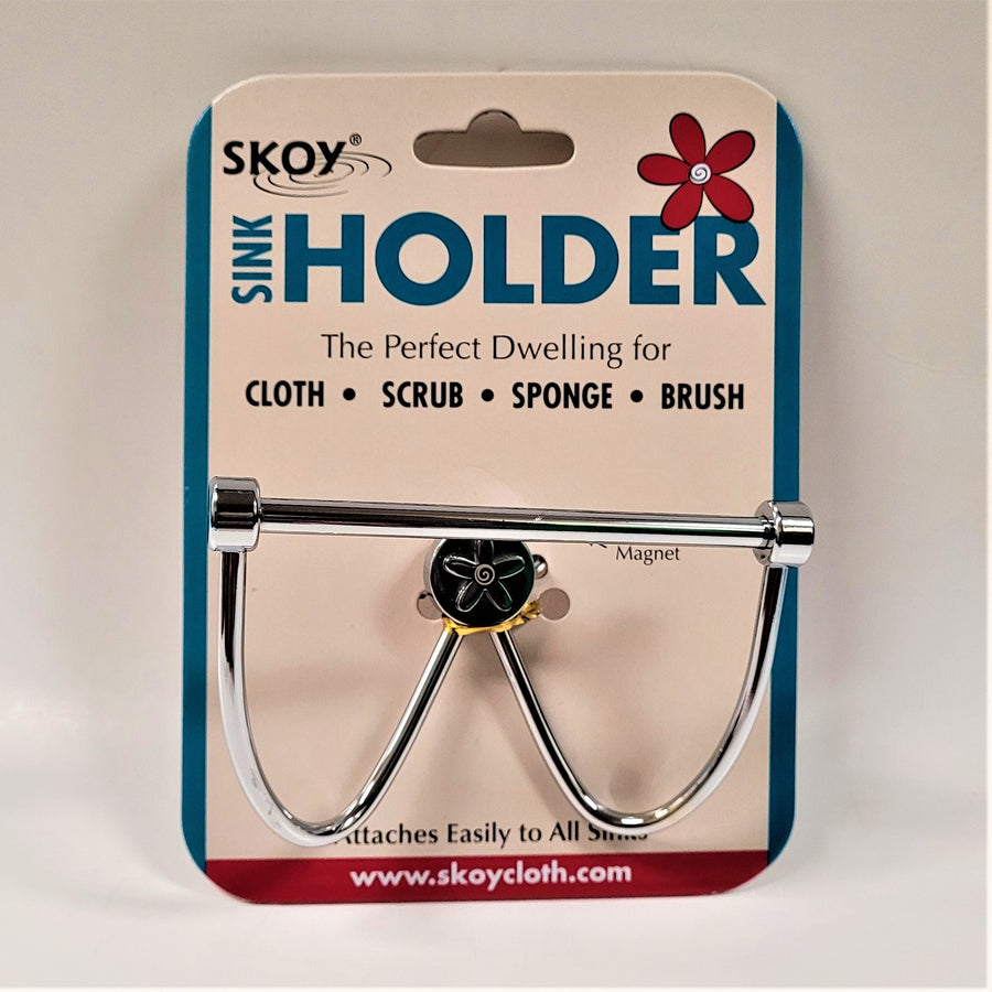 Skoy Sink Holder attached to its packing card. Metal bar with two metal curves.