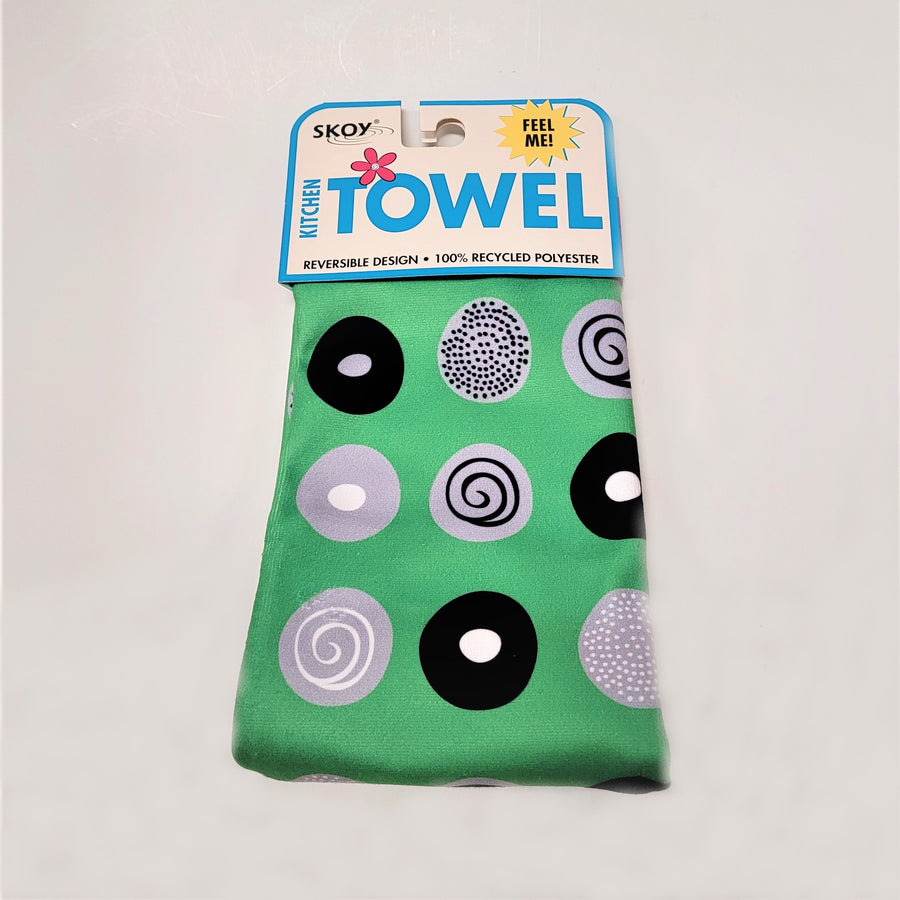 Green Skoy dishtowel with package label on top. Circle pattern print on the solid green colored in black, white and gray.