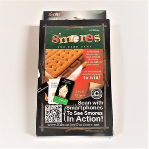 S'Mores card game in boxed packaging. Black box with inside wood-like frame, green rectangular top under type, partial picture of s'mores on red background. Bottom white type with QR code for smartphones.