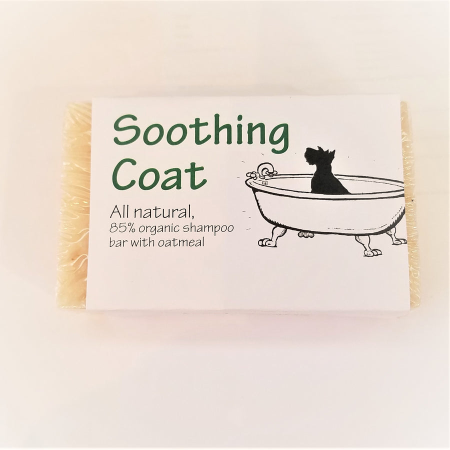 Bar of Soothing coat dog soap wrapped in clear wrap with white label depicting a silhouette of a dog in a clawfoot bathtub.